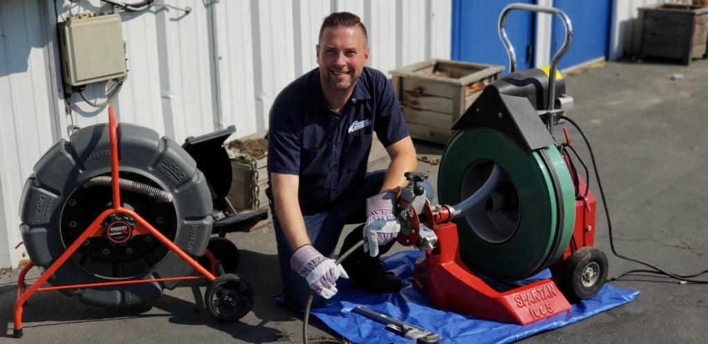 Pioneer Plumbing technician preparing equipment for a Seattle service call Pioneer Plumbing technician preparing equipment for a Seattle service call
