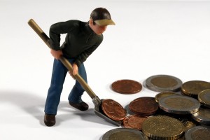 figurine man shoveling money