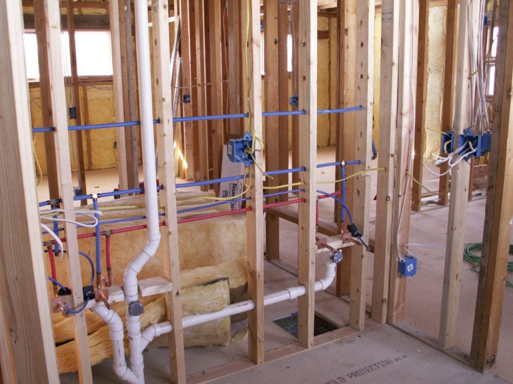 New construction rough-in plumbing with PEX lines and PVC drains